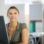 Woman working at a desk computer